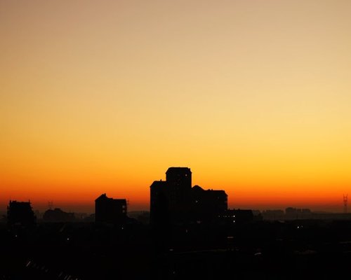 Sunrise over a city skyline with calm morning colors